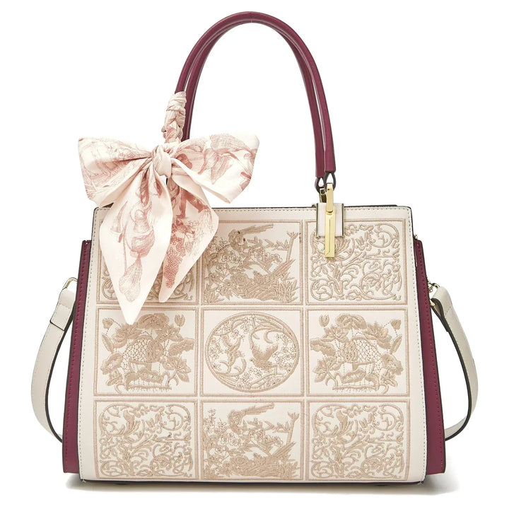 Sylvia™ – Wyjątkowa torebka crossbody z haftem i kokardą