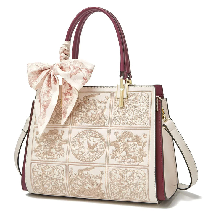 Sylvia™ – Wyjątkowa torebka crossbody z haftem i kokardą